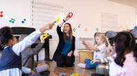 Elementary music teacher leading students in instrument play