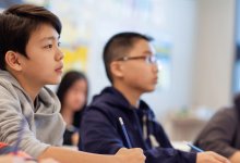 Middle school students listening to their teacher carefully
