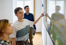 Students working at a smartboard