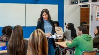 Teacher walking among students in her classroom