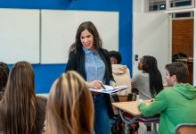 Teacher walking among students in her classroom
