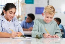 Middle school students writing in their notebooks during science class