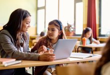 Elementary teacher working with student one-on-one