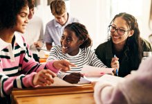 High school students reading short stories and poems together in a small group