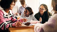High school students reading short stories and poems together in a small group