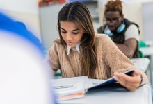High school students reading a textbook in class