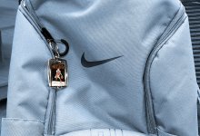 A photo of a sample book keychain on a student's backpack