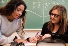 A teacher grading an assignment with the student present