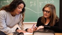A teacher grading an assignment with the student present