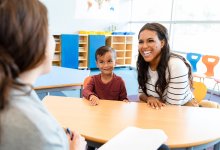 Preschool teacher meeting with a parent