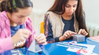 Middle school students making crafts in school