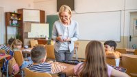 A teacher explaining new vocabulary to her elementary students