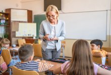 A teacher explaining new vocabulary to her elementary students