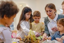 Preschool teacher working with students on a project