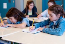 Elementary students writing in notebooks