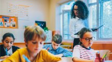 A teacher observing her students as they work