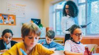 A teacher observing her students as they work