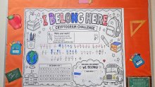 Hallway bulletin board decorated with a cryptogram puzzle