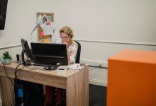 A photo of an administrator working at her desktop computer