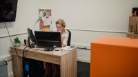 A photo of an administrator working at her desktop computer
