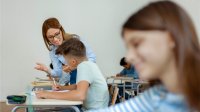 A teacher encouraging a student during class
